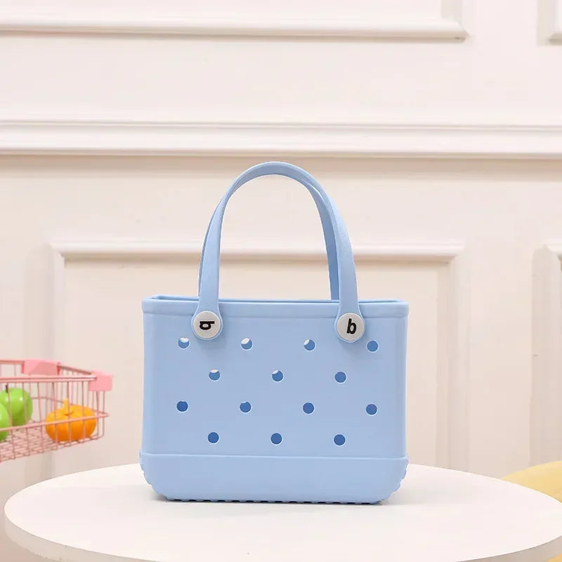 Light blue handbag with polka dot pattern on a white surface