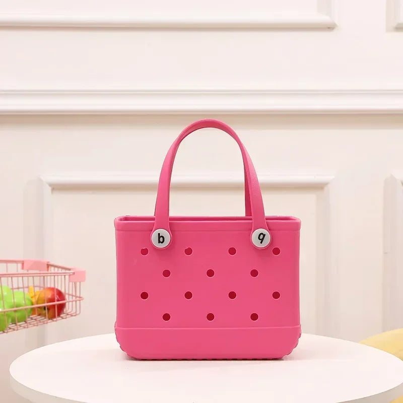Pink handbag with polka dot pattern on a white surface