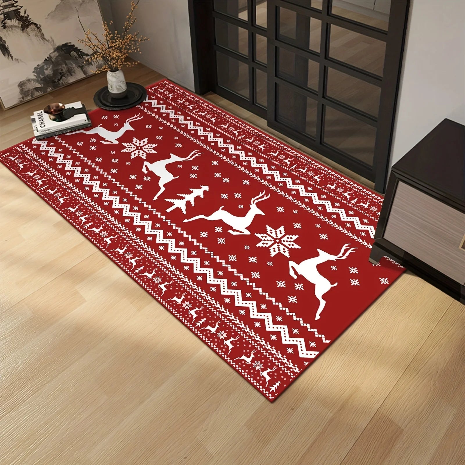 Festive red reindeer rug with holiday design used as decorative floor mat by glass door.