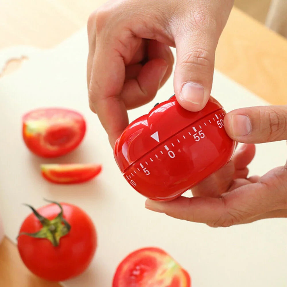 Tomato kitchen timer being used for cooking countdown