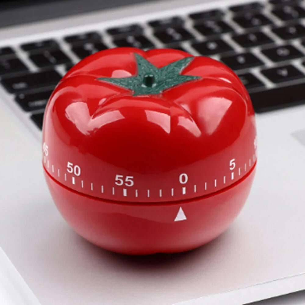 Tomato-shaped mechanical countdown timer on office desk