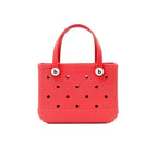 Red handbag with perforated design and 'b' logo on a white background