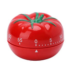 Red tomato-shaped mechanical kitchen timer for cooking