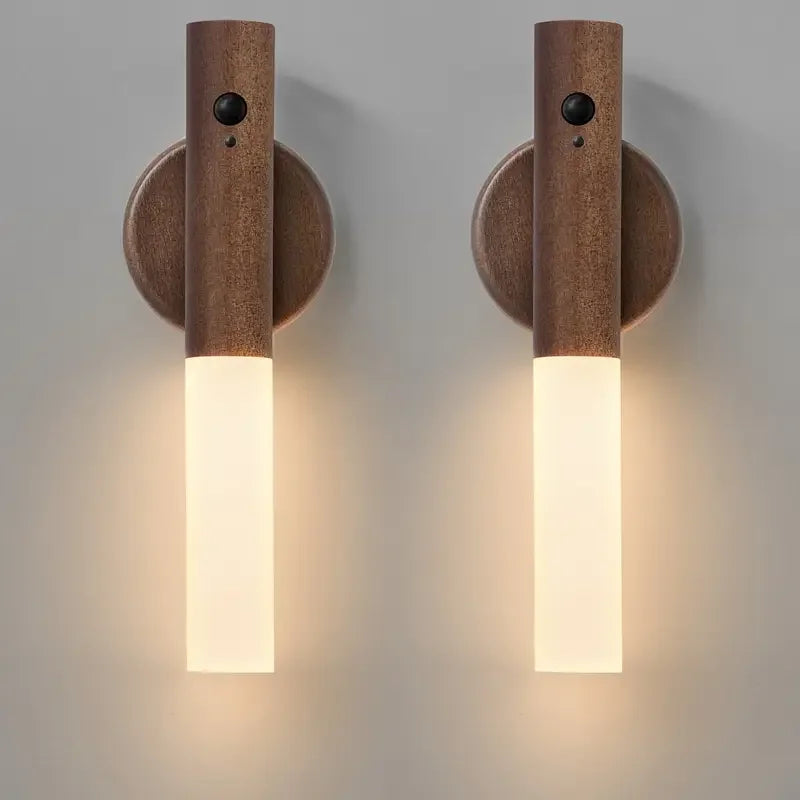 Two wooden wall sconces with cylindrical design on a gray background